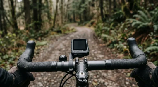 Professional cyclist reviewing bike computer mounted on handlebars during outdoor ride