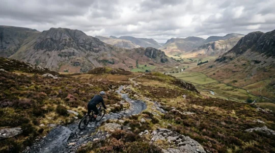 Mountain biker maintaining flow through rocky Lake District singletrack without braking